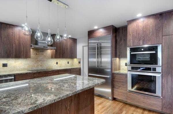 These granite counter slabs make the island have a clean look. The stainless steel appliances completely ties this modern kitchen together