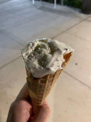 Cookies and cream ice cream with waffle cone (half eaten)