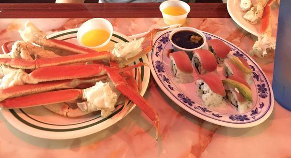 A plate of crab legs and sushi.