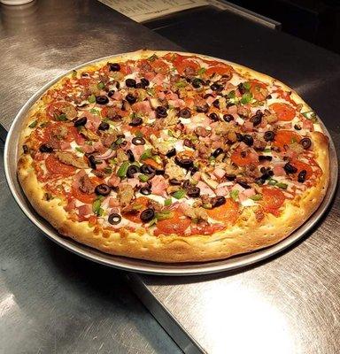 The Supreme is Pepperoni, Mushroom, Green Pepper, Red Onion, Black Olive, Ham. Ground Beef, and Italian Sausage