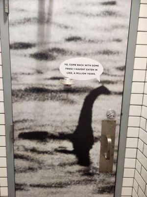 Inside the restroom door is the loch Ness Monster