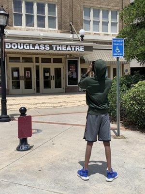 My son taking a photo of the Douglass Theater for a documentary he producing.