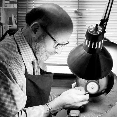 Hand finishing a ring.