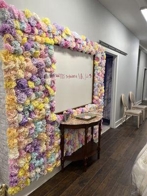 Signature flower wall. Any bride who buys a dress here at MK Bridal gets to sign the wall