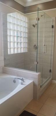 90 degree buttress type ( frameless ) shower enclosure mounted on top of a pony wall