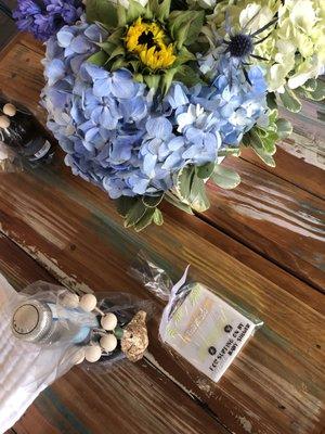 Beautiful flowers for a baby shower - blue and white hydrangeas, sunflowers, tulips thistle, pom pom and roses -- rave compliments from all!