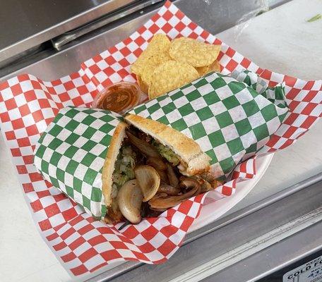 This is our Torta de Pollo(chicken), with grilled onions on the side along with tortilla chips and a side of our red sauce!