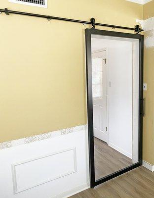 Barn door with exposed hardware