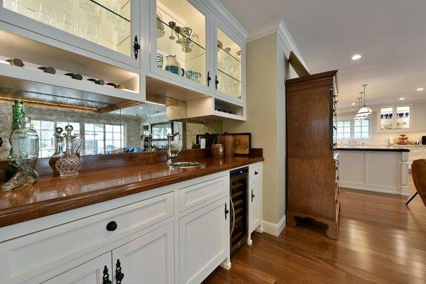 Buffet Base Cabinet with Built-In wine fridge Walnut top and Uppers with Inset Doors cut for glass.