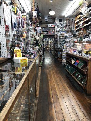 The shelving, counter, floor, and rolling wall ladder are original dating back into the 1850s.