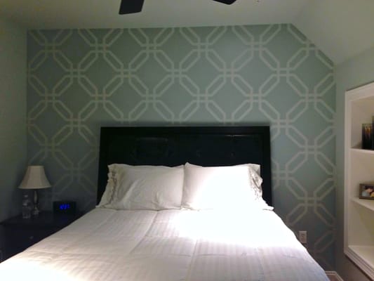 Master bedroom accent wall with geometric pattern.