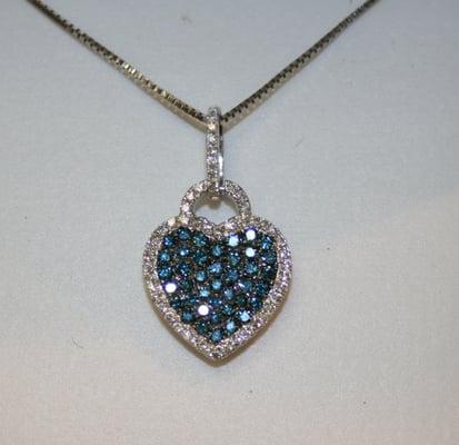 18K White gold heart shape pendant with irradiated blue diamonds surrounded by white diamonds