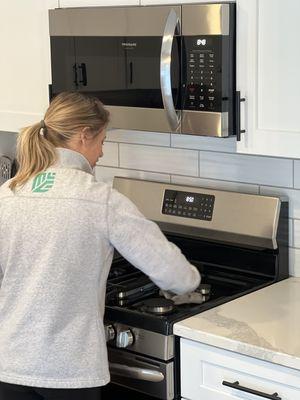 Cleaning a stove top.