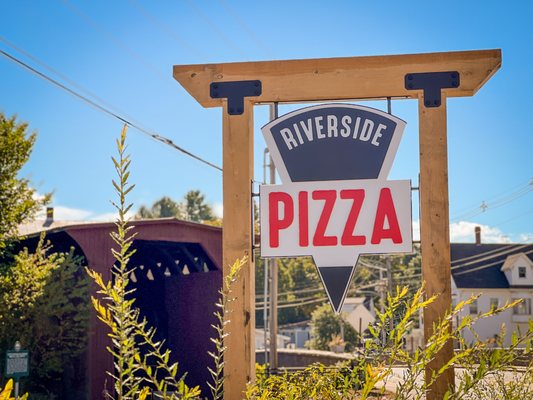 Our street sign with historic covered bridge in the background