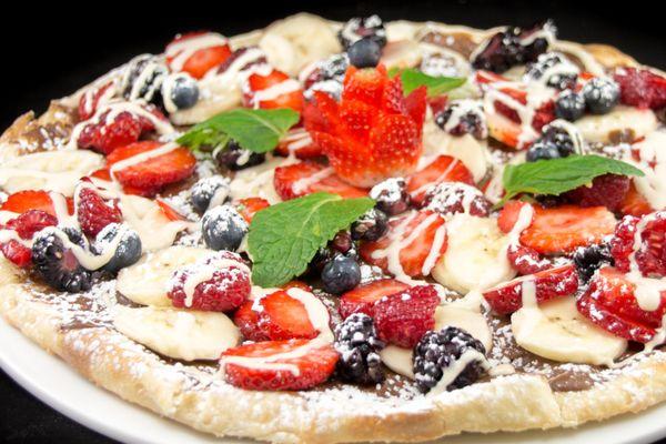 Our fan-favorite dessert pizza. 
 
 Fruitella pizza- covered in nutella and topped with fresh fruit and vanilla drizzle