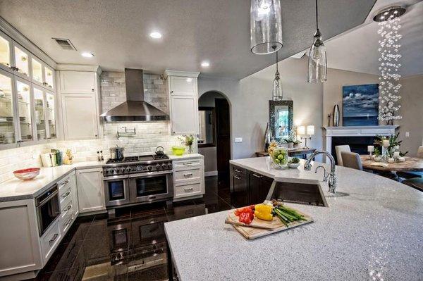 Gorgeous Dove Tail recycled glass countertops pair beautifully with white shaker cabinets to create an inviting kitchen vibe.