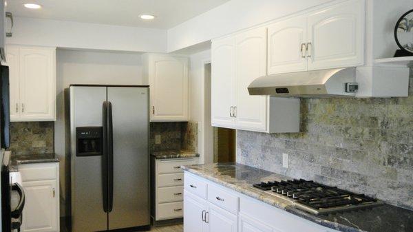 Kitchen remodel using existing cabinet frames with new doors. Granite counter tops with tile back splash.