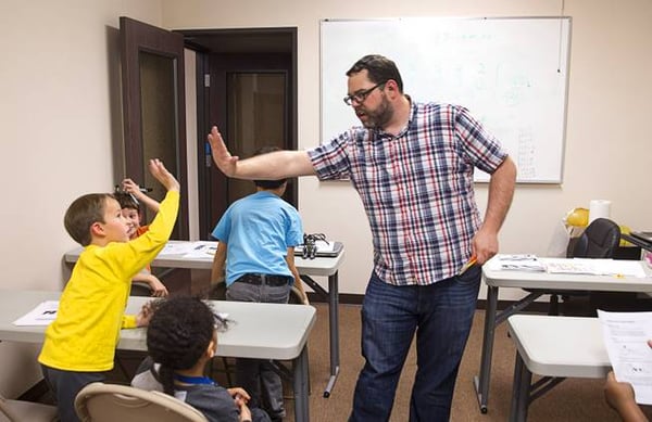 Celebrating student success with a high five.