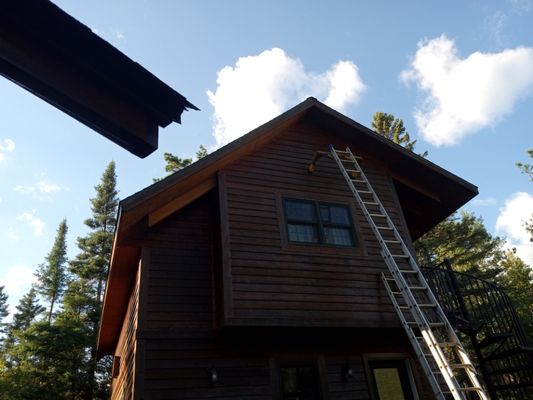 Staining and caulking cedar siding