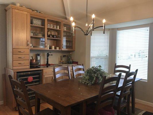 Custom designed hutch includes wine refrigerator and storage for convenience when entertaining