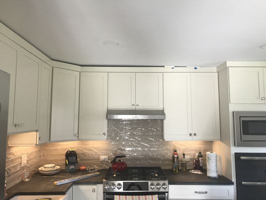 Crooked cabinets and hood. The cabinets actually drop by half an inch as they turn the corner.