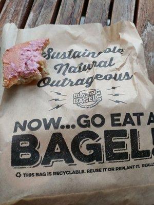 What's left of my sesamw bagel with berry cream cheese and the recyclable, plantable bagel bag