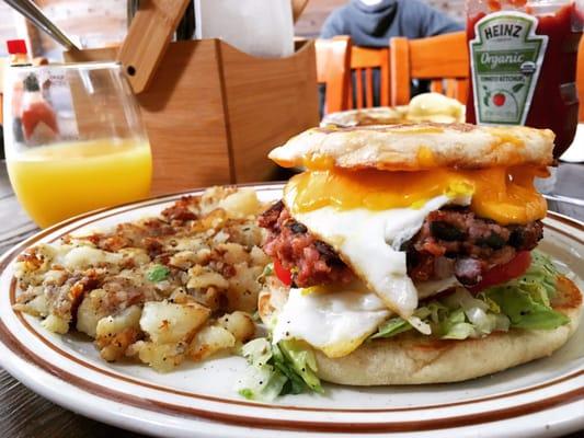 Breakfast sandwich: 2 fried eggs, lettuce, tomato, cheddar, house-made organic brown rice and black bean patty, on an English muffin