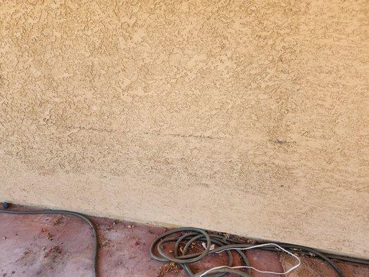 The black scrape across my stucco wall from the lift bar