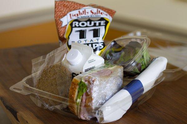 Atwater's lunch box- half sandwich, salad, chips, cookie and water.