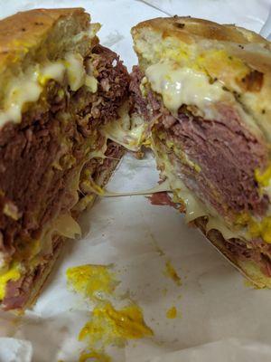 Mr. Corn beef on an onion roll with extra swiss cheese and mustard.