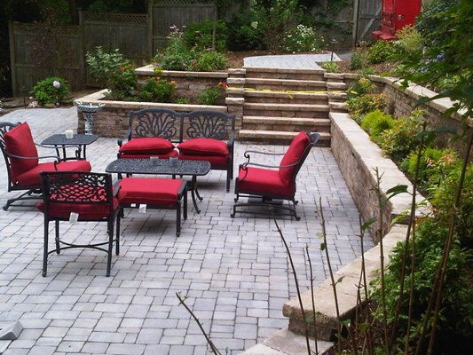 A sloped backyard has potential for installing a patio, ask us for suggestions