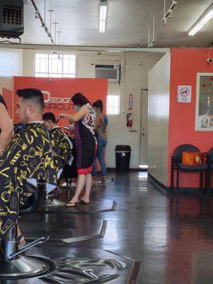 3 stylist cutting hair, more than 6 feet apart.  Clara, Lin, and Francis in the back.