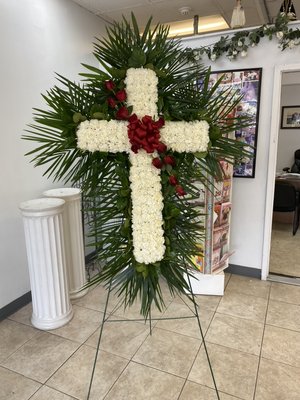 White cross with red rose cluster.