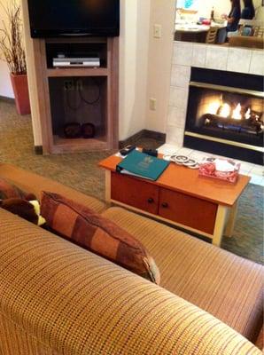 Living room with fireplace and entertainment center.