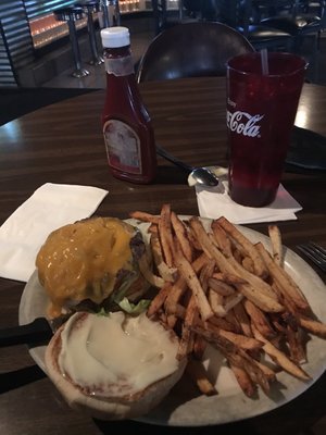 Great tasting old fashioned cheeseburger with a bunch of fries.