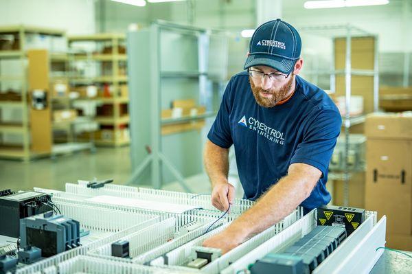 Cybertrol Engineering Employee Working on Control Panel Assembly