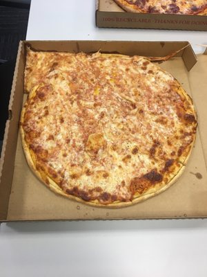 Pizza with half the cheese in the corner of the box.