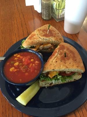 Spicy chicken grilled sandwich on focaccia and cup of vegetable soup