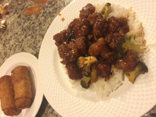 Orange chicken with white rice & egg rolls on the side (to-go order plated at home).