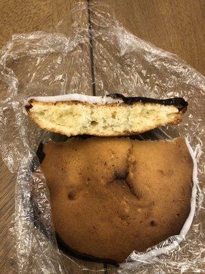 Over-baked Black and white cookie with a burn spot on the bottom.