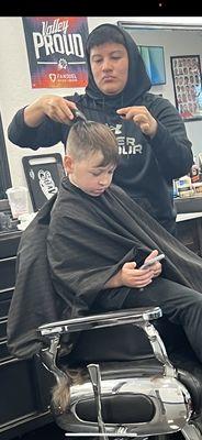 Stylist and my child during hair cut