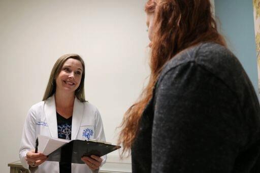 Lara Lovell Nurse Practitioner with a patient.