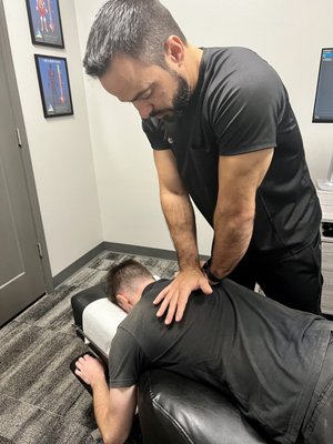 Dr.Jenkins performing an upper back adjustment.