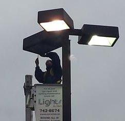 Parking lot pole light repair.