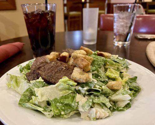 Caesar salad with steak and a Diet Coke