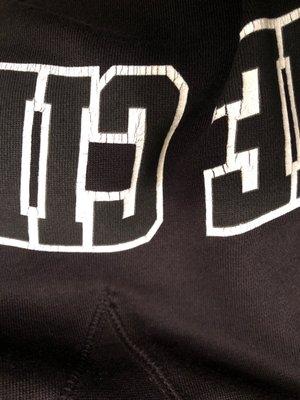 Cracked lettering on ruined sweatshirt