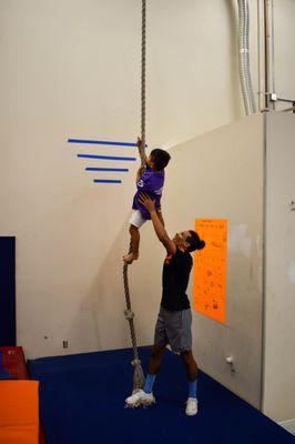 One knot at a time, we teach athletes to climb to the top of the rope. Small goals lead to big accomplishments!