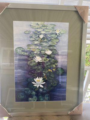 The framed painting of Lakeshrine Lilies