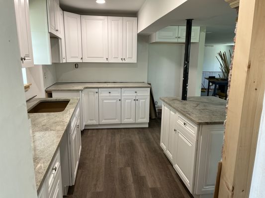 Custom kitchen before column framed around support pole on island.  Granite countertops complete this pretty picture