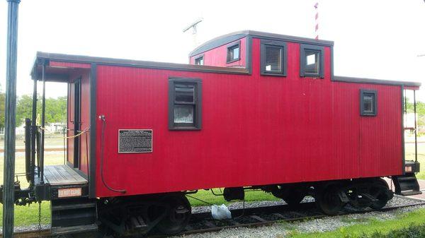 By the chamber of commerce and art studio building along the rail line.